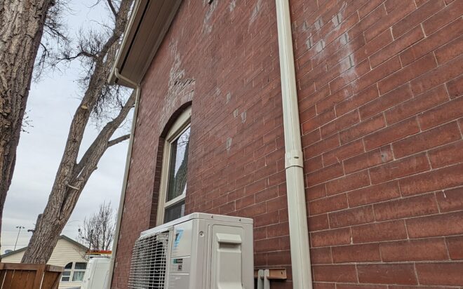 A bronco Breeze heat-pump installed on the wall of a Denver home