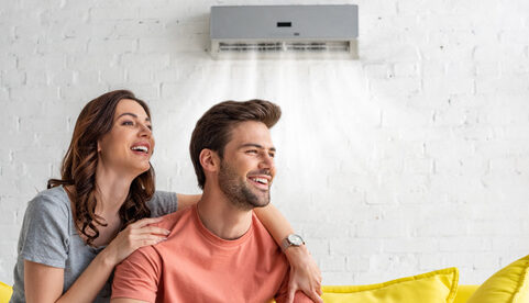 Couple Sitting On Sofa Under AC